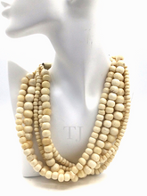 Загрузить изображение в средство просмотра галереи, Bovine Bead Layered Necklace hanging on a doll's neck