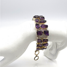 Load image into Gallery viewer, High Quality Amethyst Faceted cut stones bracelet in sterling silver being hung on the doll's hand