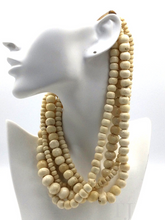 Загрузить изображение в средство просмотра галереи, Bovine Bead Layered Necklace hanging on a doll's neck