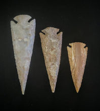 Load image into Gallery viewer, Three different sizes of Arrow Head symbols made with stones.