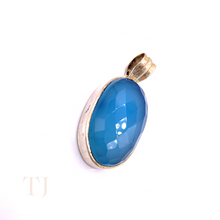 Load image into Gallery viewer, Blue Calcedony faceted oval shape in a sterling silver setting pendant with a bail