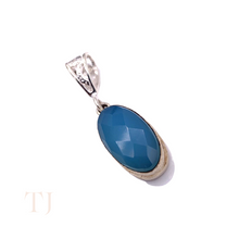 Load image into Gallery viewer, Blue Calcedony faceted oval shape in a sterling silver setting pendant with a bail
