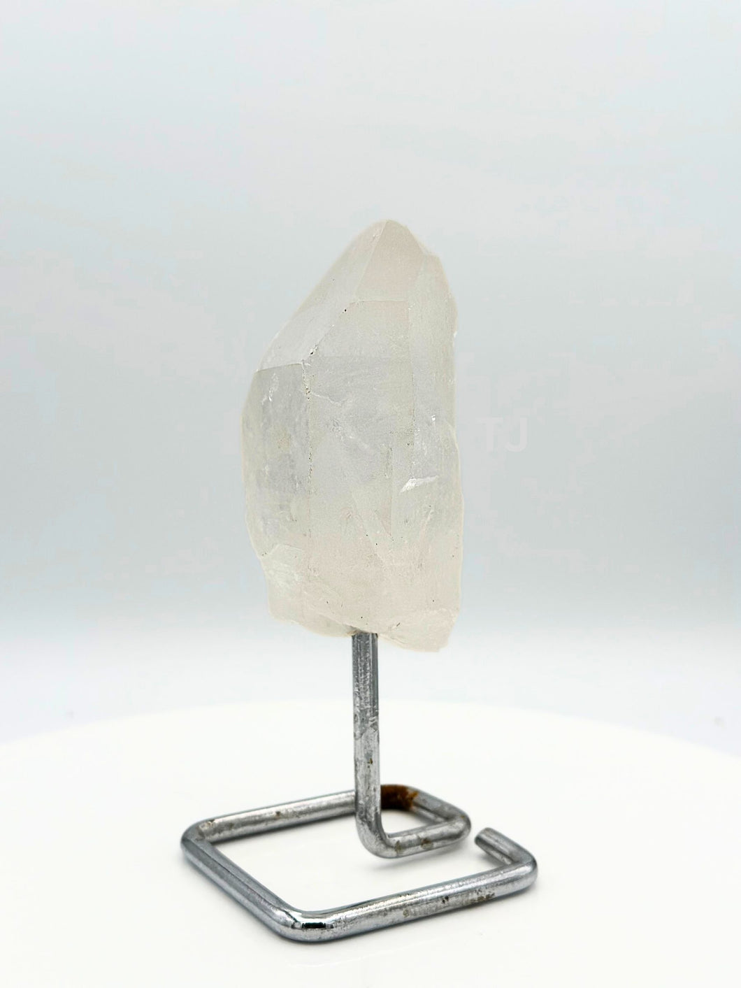 Quartz point crystal on stand