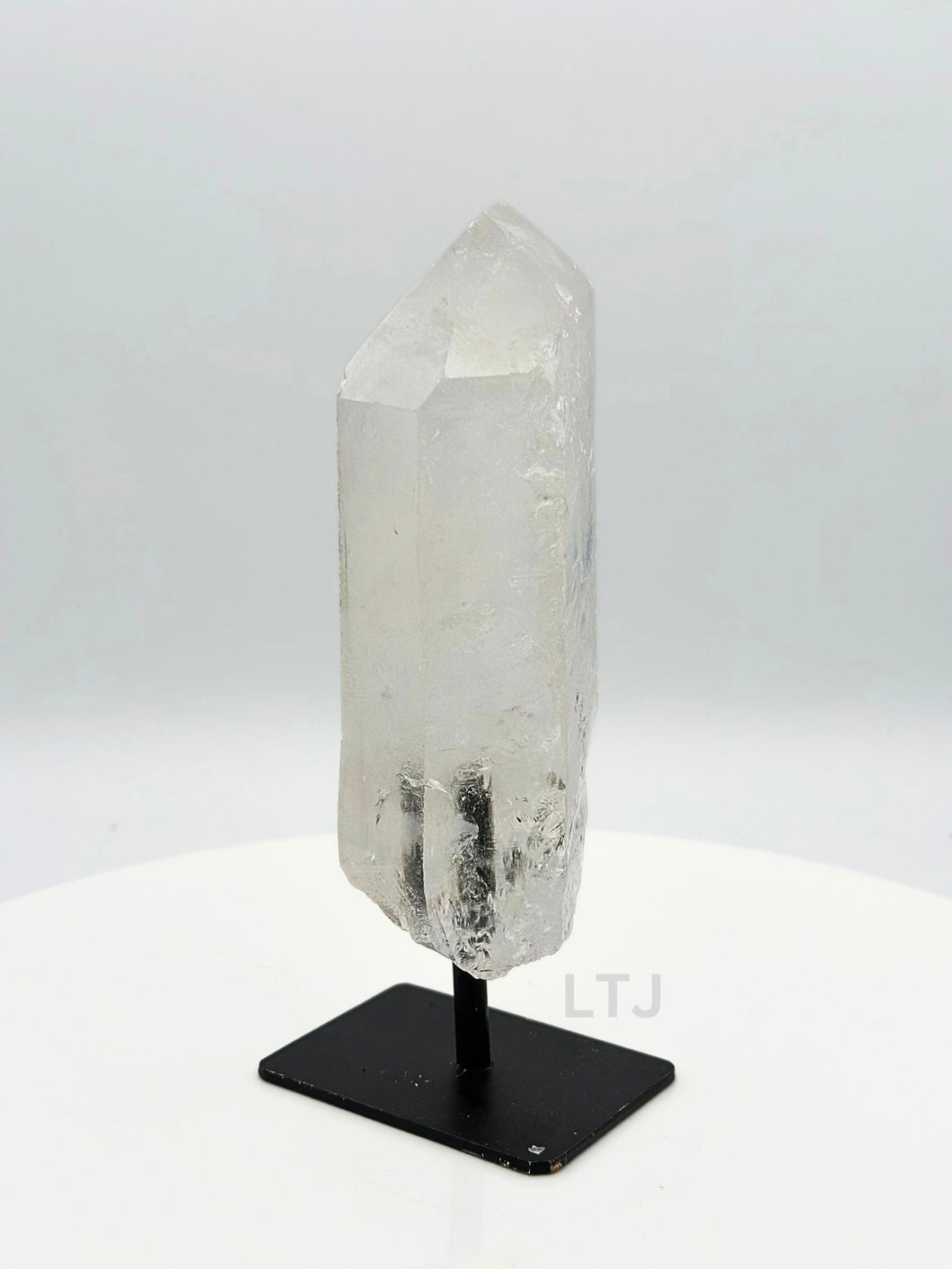 Quartz point crystal on stand