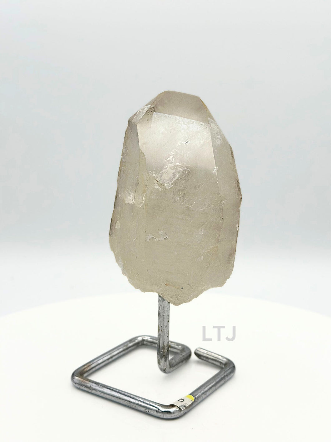 Quartz point crystal on stand