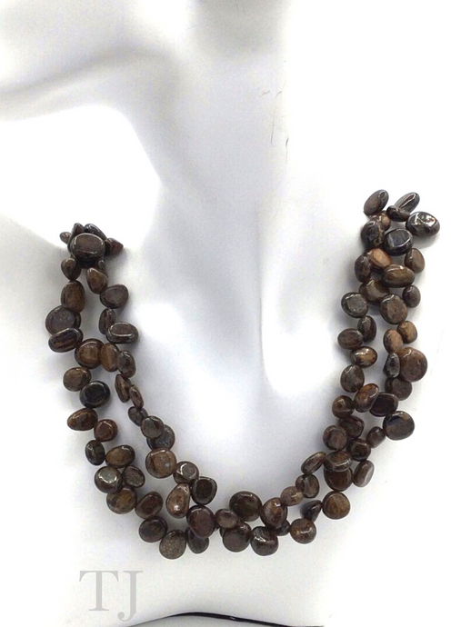 Bronzite chip layered necklace hanging on a dolls's neck