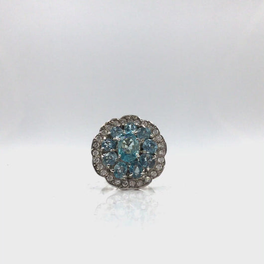 360 video of Aquamarine oval cut stones in flower shaped setting ring with diamonique