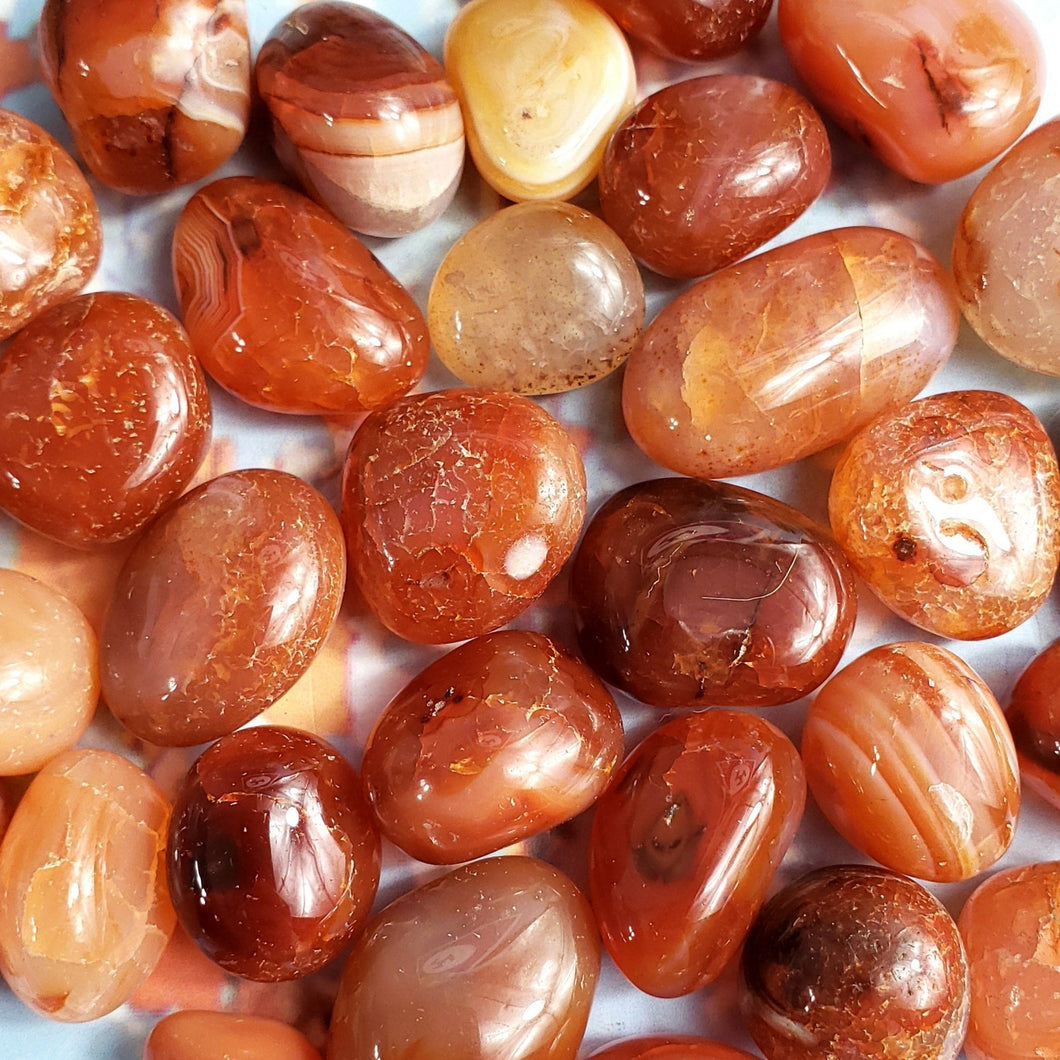 A bunch of Carnelian tumbled stones