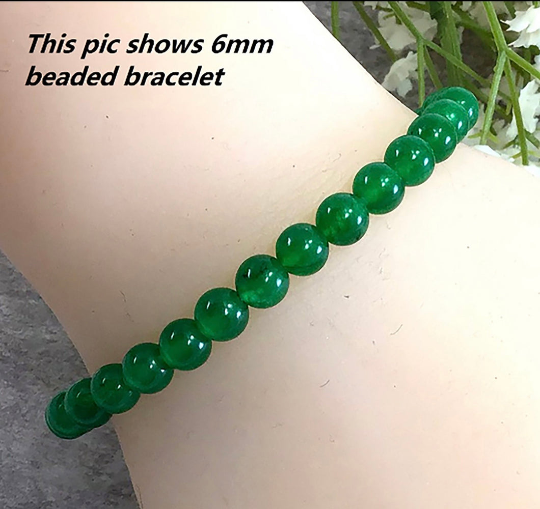 Dyed Jade bead bracelet, 6mm bead size, on a doll's hand