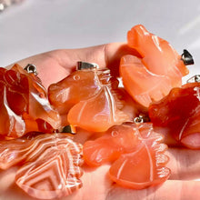 Load image into Gallery viewer, Carnelian Horse Figure Pendants on a hand
