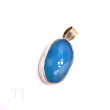 Загрузить изображение в средство просмотра галереи, Blue Calcedony faceted oval shape in a sterling silver setting pendant with a bail
