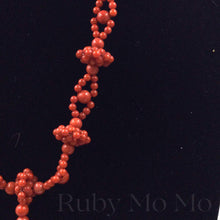 Load image into Gallery viewer, side view of Australian Coral Bead Necklace with flower shaped pendant
